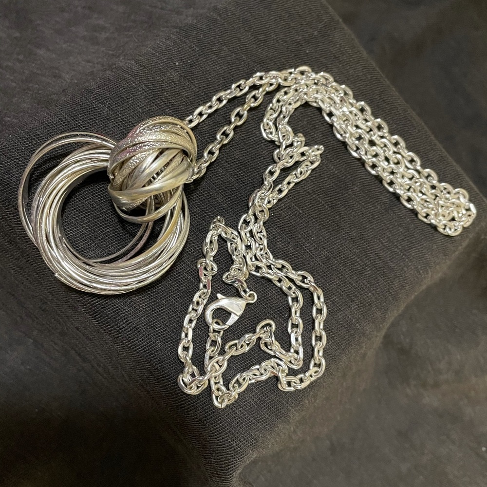 Silver long chain with a silver ball @ the end.